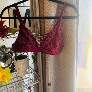 Dark red bikini top with gold chains and pompoms